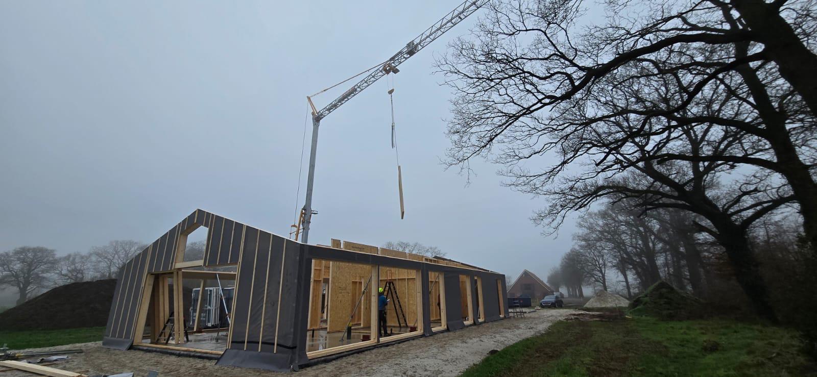 Wandelementen van een schuurwoning die met de kraan worden geplaatst